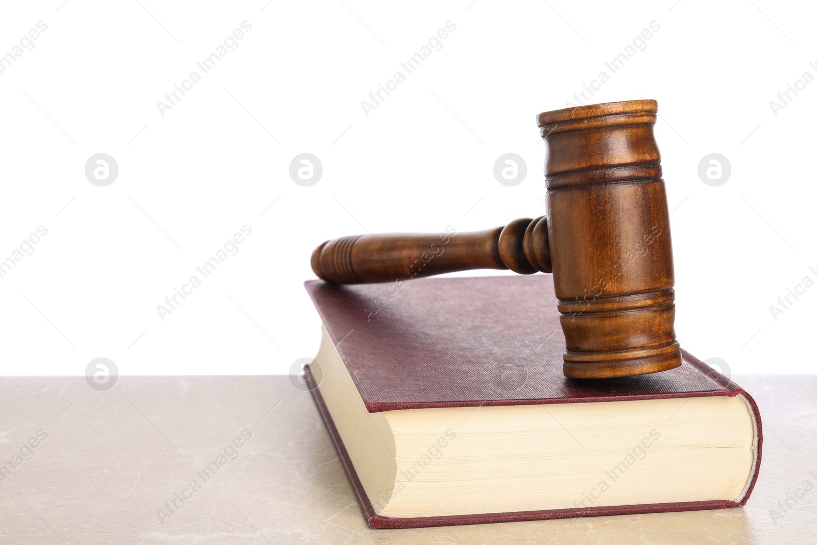 Photo of Wooden gavel and book on light table against white background. Space for text