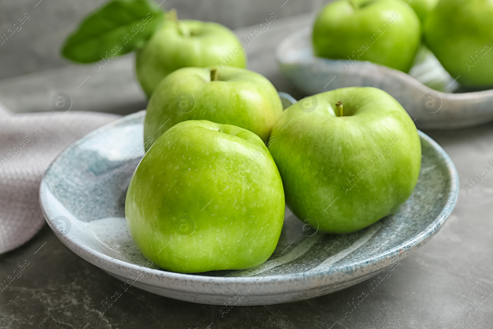 Photo of Plate with fresh green apples on table, closeup