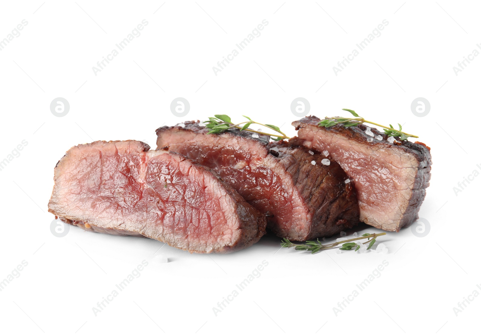 Photo of Delicious sliced beef steak with thyme and salt isolated on white