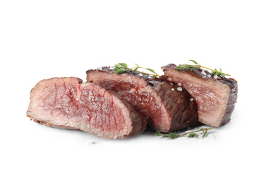 Photo of Delicious sliced beef steak with thyme and salt isolated on white