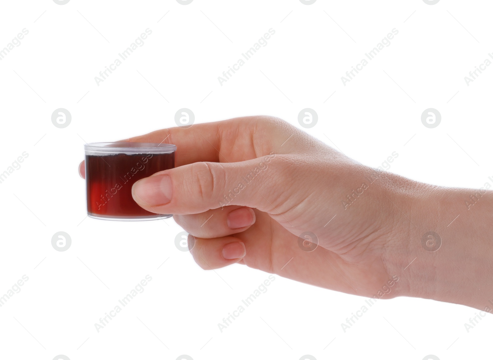 Photo of Woman holding measuring cup with syrup isolated on white, closeup. Cough and cold medicine