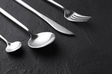 Beautiful cutlery set on black table, closeup