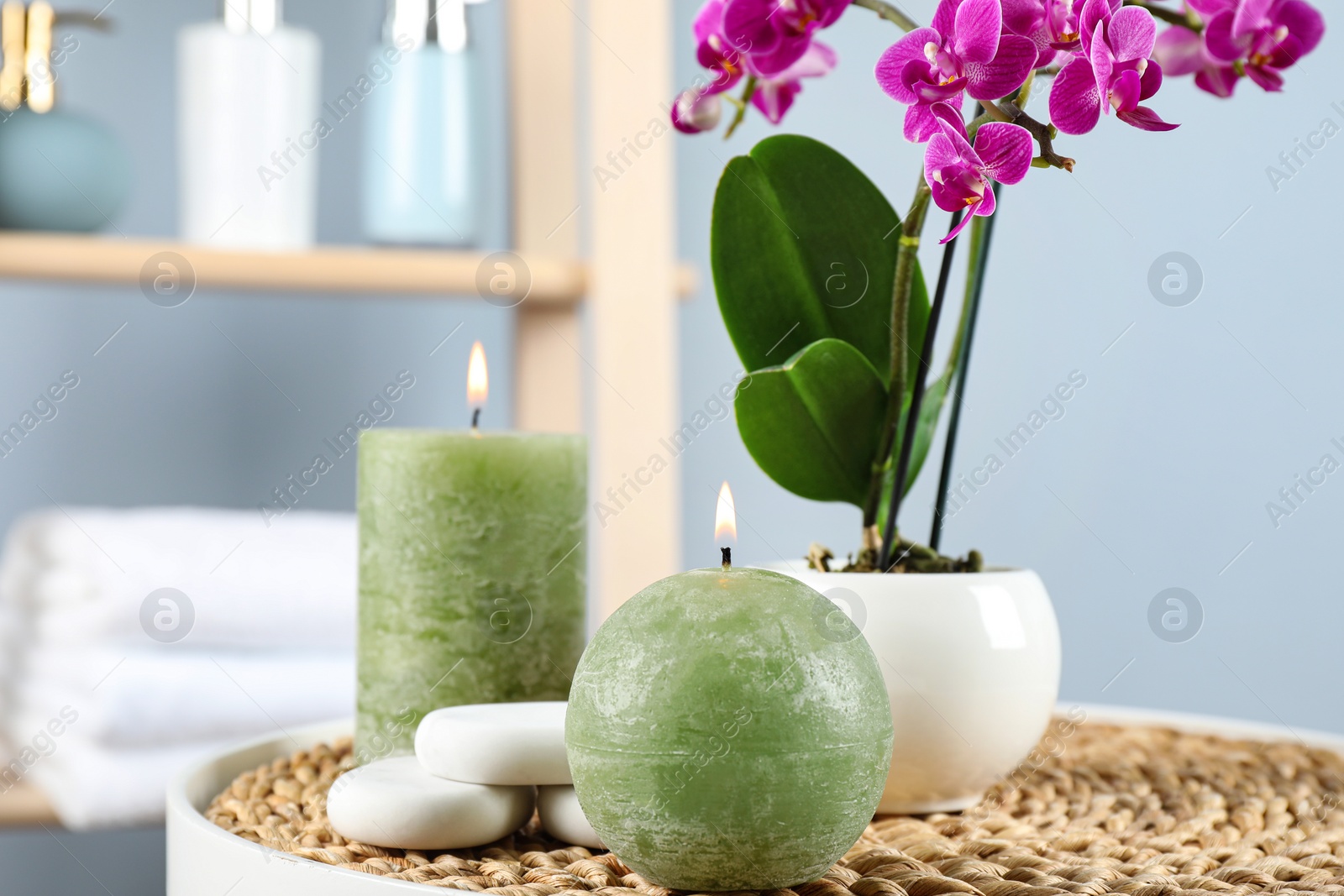 Photo of Spa accessories and blooming orchid on table indoors