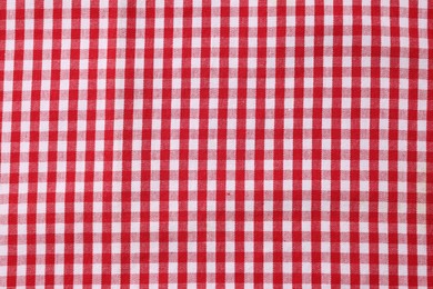 Red checkered tablecloth as background, top view