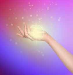Image of Woman holding concentrated healing energy in her hand, closeup