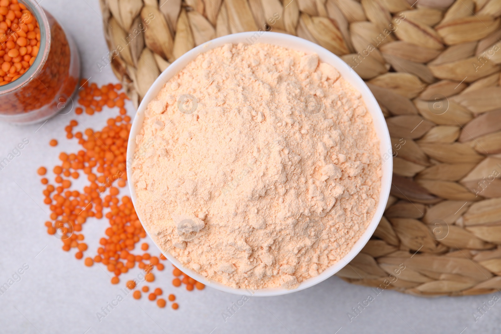 Photo of Lentil flour and seeds on white table, flat lay