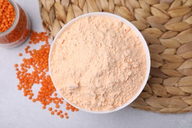 Lentil flour and seeds on white table, flat lay