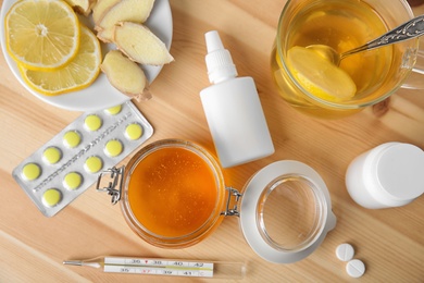 Flat lay composition with different cold remedies on wooden table