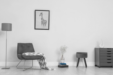 Photo of Room interior with stylish furniture near white wall