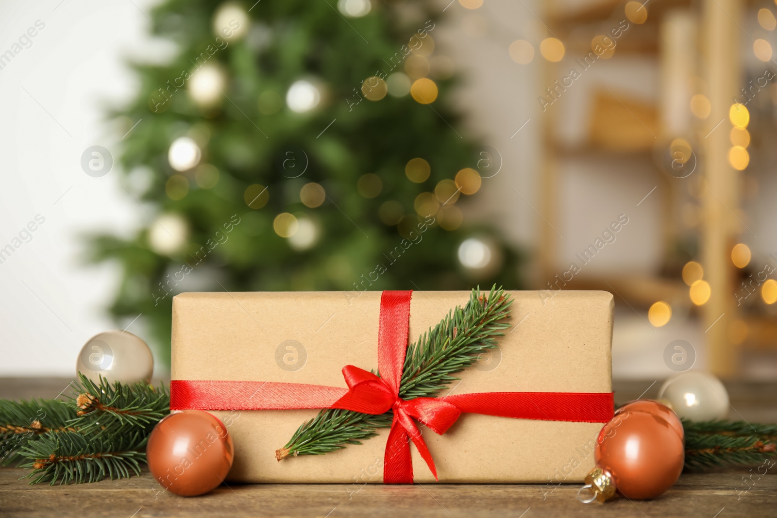 Photo of Beautiful gift box and Christmas decor on wooden table