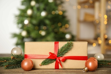 Photo of Beautiful gift box and Christmas decor on wooden table