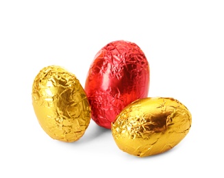 Chocolate eggs wrapped in bright foil on white background