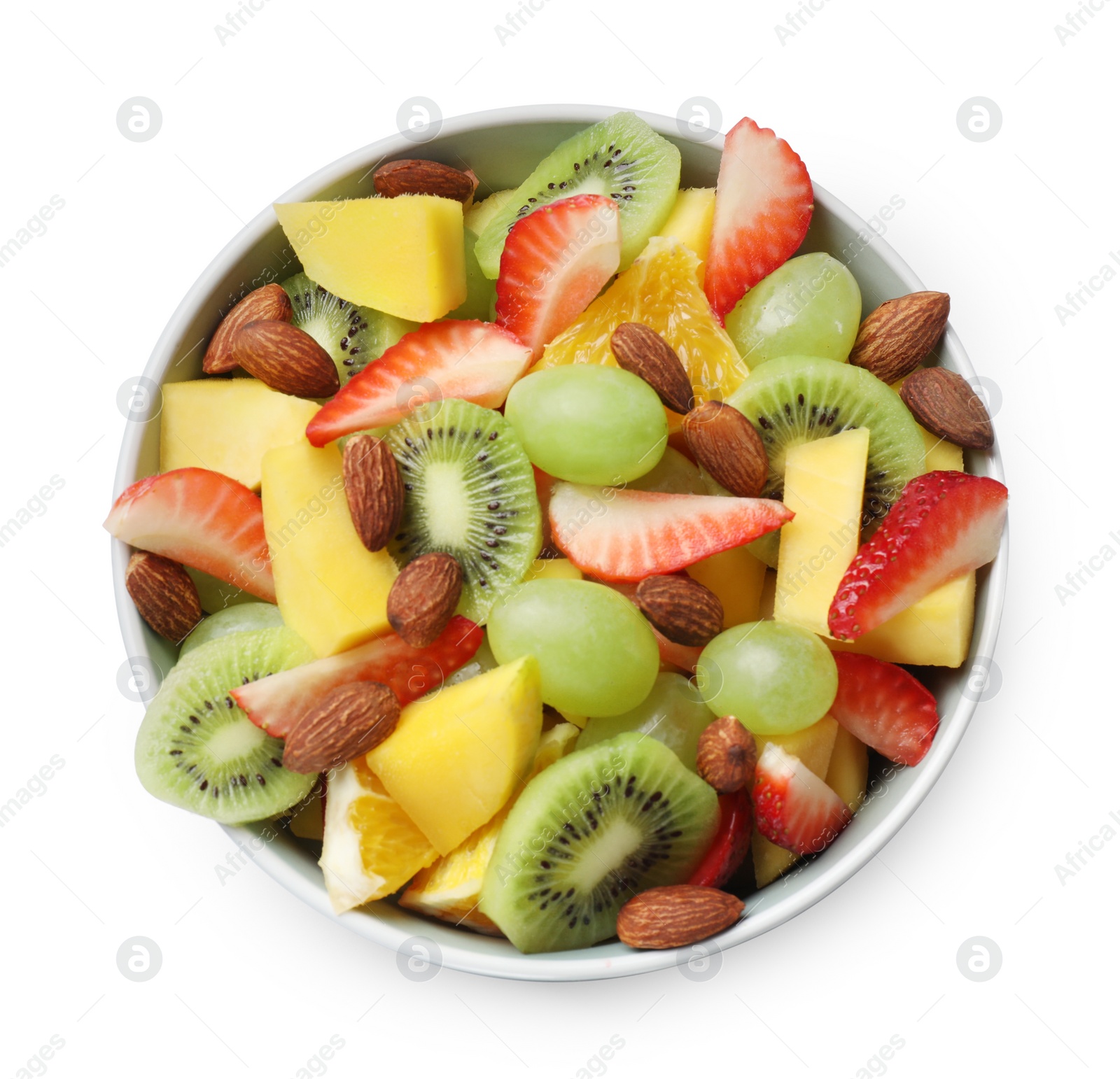 Photo of Tasty fruit salad in bowl isolated on white, top view