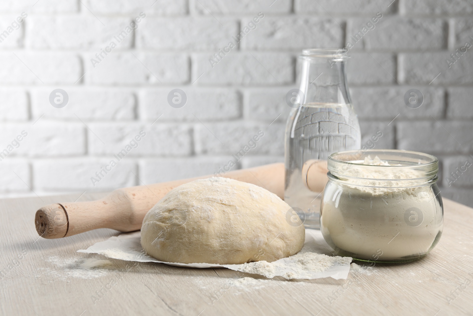 Photo of Cooking scones with soda water. Dough and ingredients on white wooden table