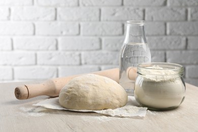 Photo of Cooking scones with soda water. Dough and ingredients on white wooden table