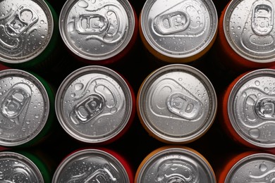 Photo of Energy drinks in wet cans, top view. Functional beverage