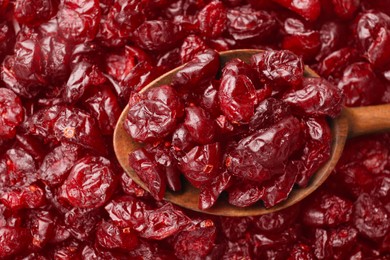 Photo of Many dried cranberries and spoon, top view