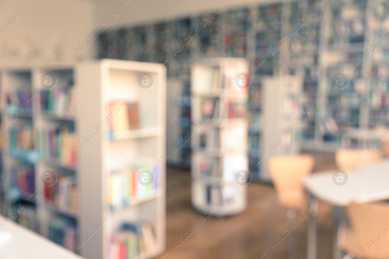 Photo of Blurred view of library interior with bookcases and tables