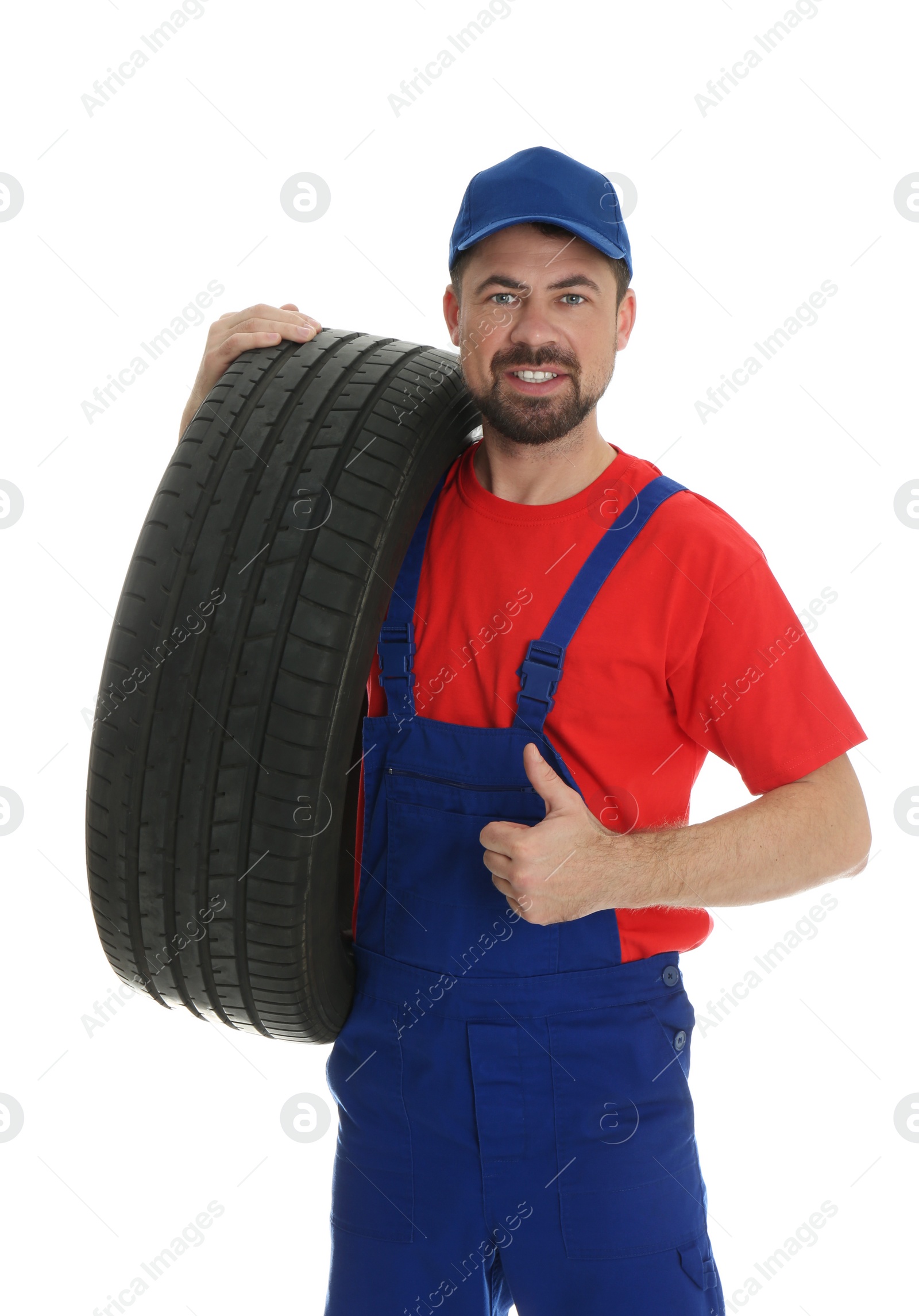 Photo of Portrait of professional auto mechanic with tire on white background