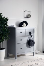 Grey chest of drawers in stylish room. Interior design