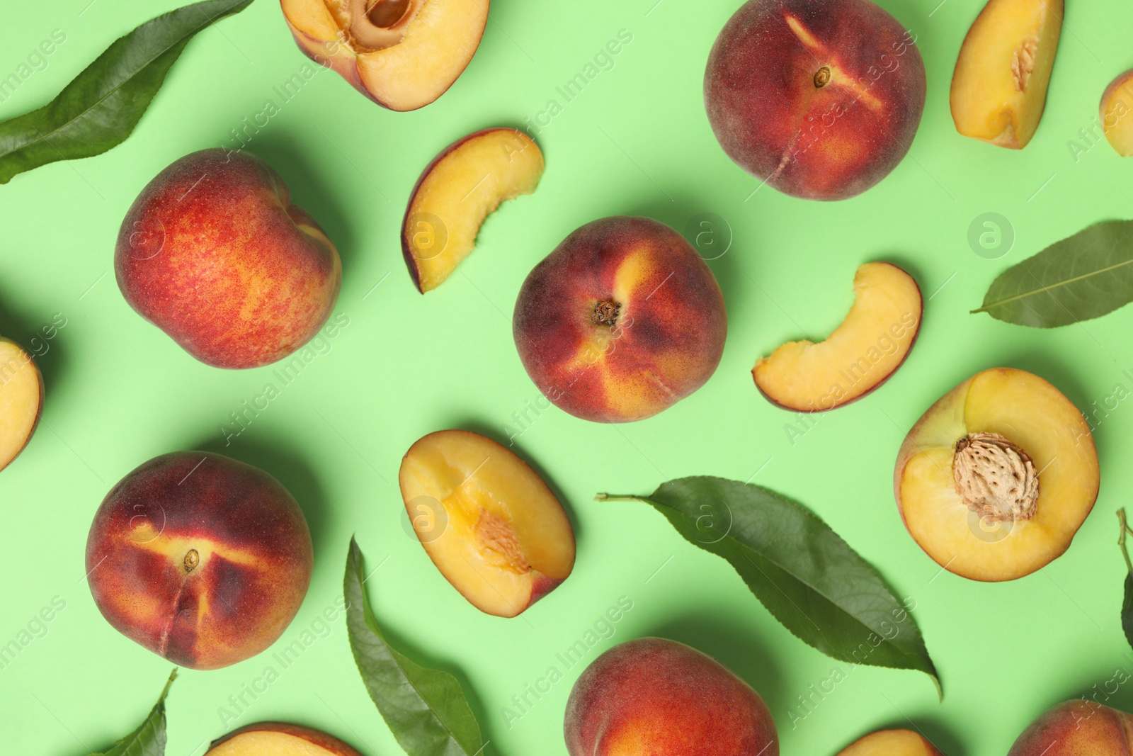 Photo of Flat lay composition with sweet juicy peaches on green background