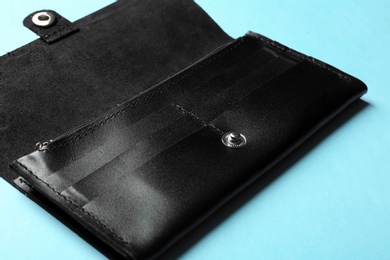 Photo of Open leather wallet on color background, closeup