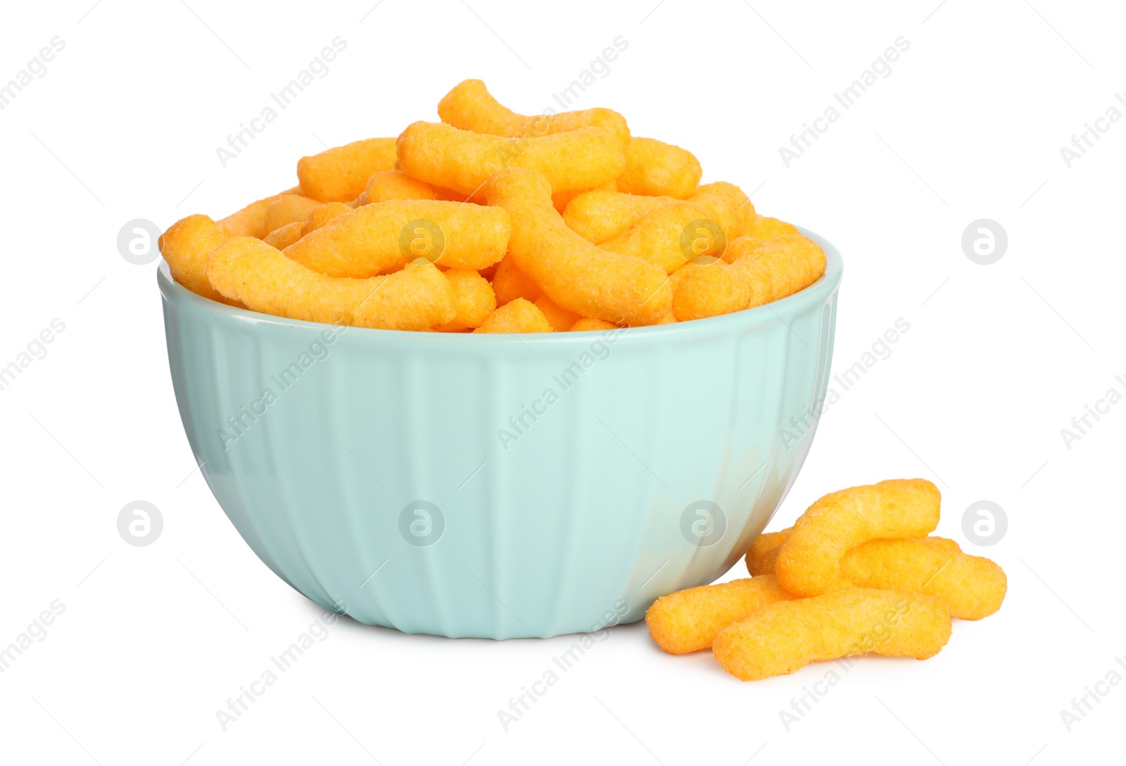 Photo of Many tasty cheesy corn puffs in bowl isolated on white