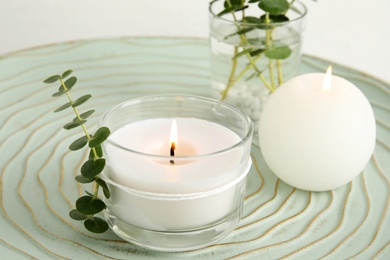 Photo of Composition with burning aromatic candles and eucalyptus on table