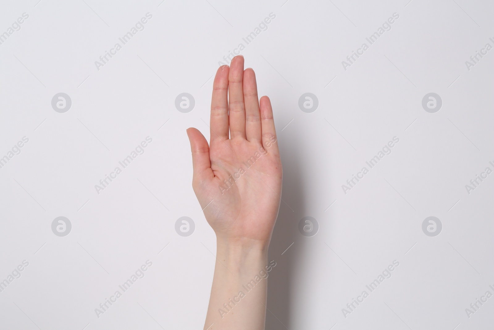 Photo of Woman showing open palm on white background, closeup