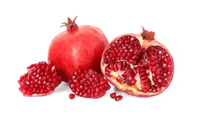 Half and whole pomegranates isolated on white