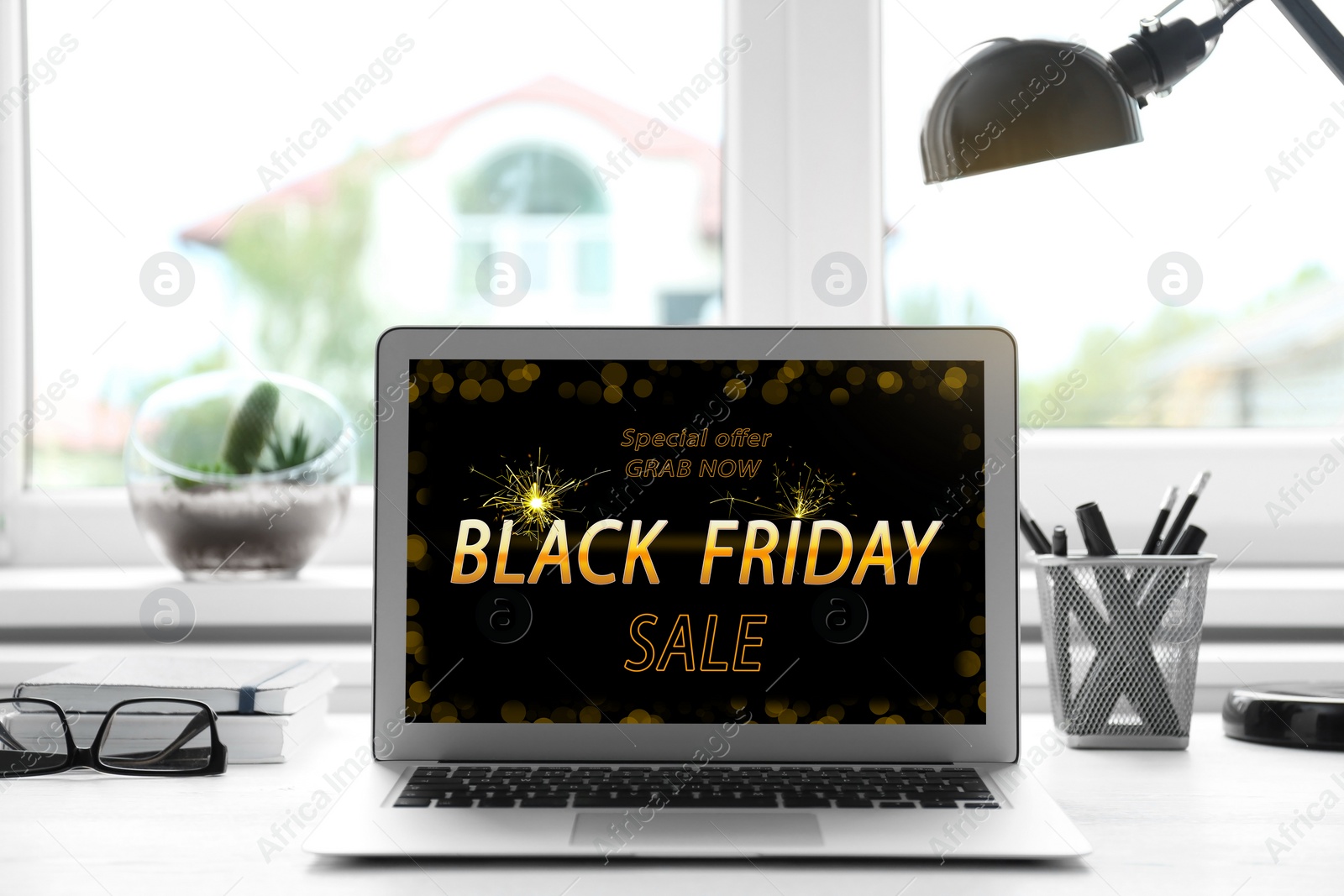 Image of Black Friday announcement on laptop screen. Online shopping