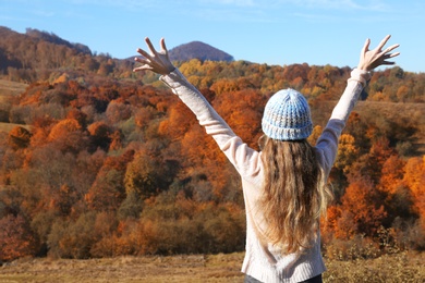 Photo of Female traveler feeling free in peaceful mountains