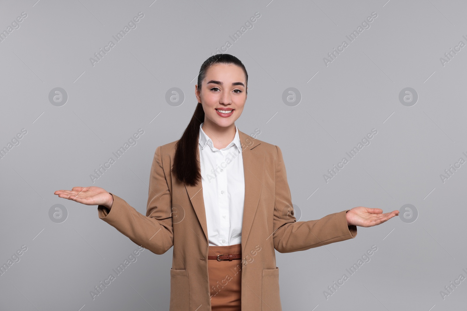 Photo of Happy real estate agent on grey background