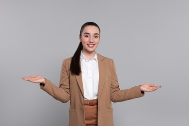 Photo of Happy real estate agent on grey background