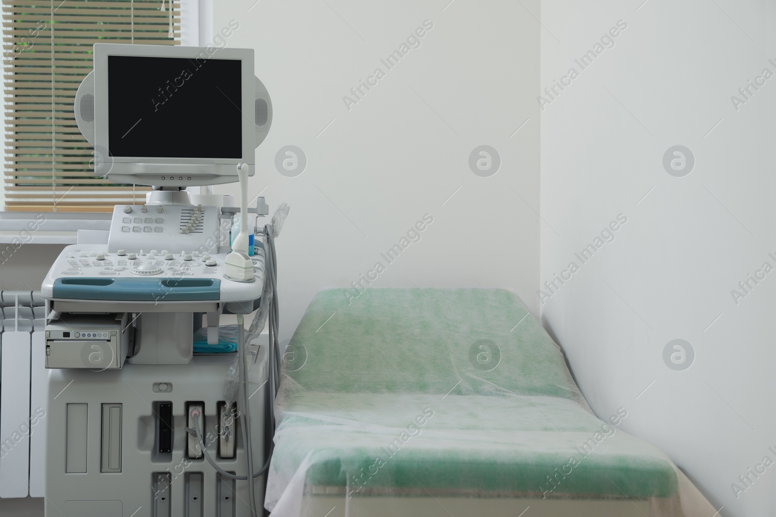 Photo of Ultrasound machine and examination table in hospital