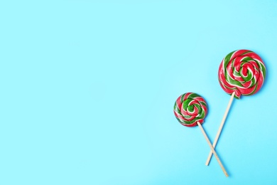Photo of Tasty candies and space for text on color background, top view