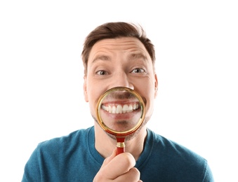 Smiling man with perfect teeth and magnifier on white background