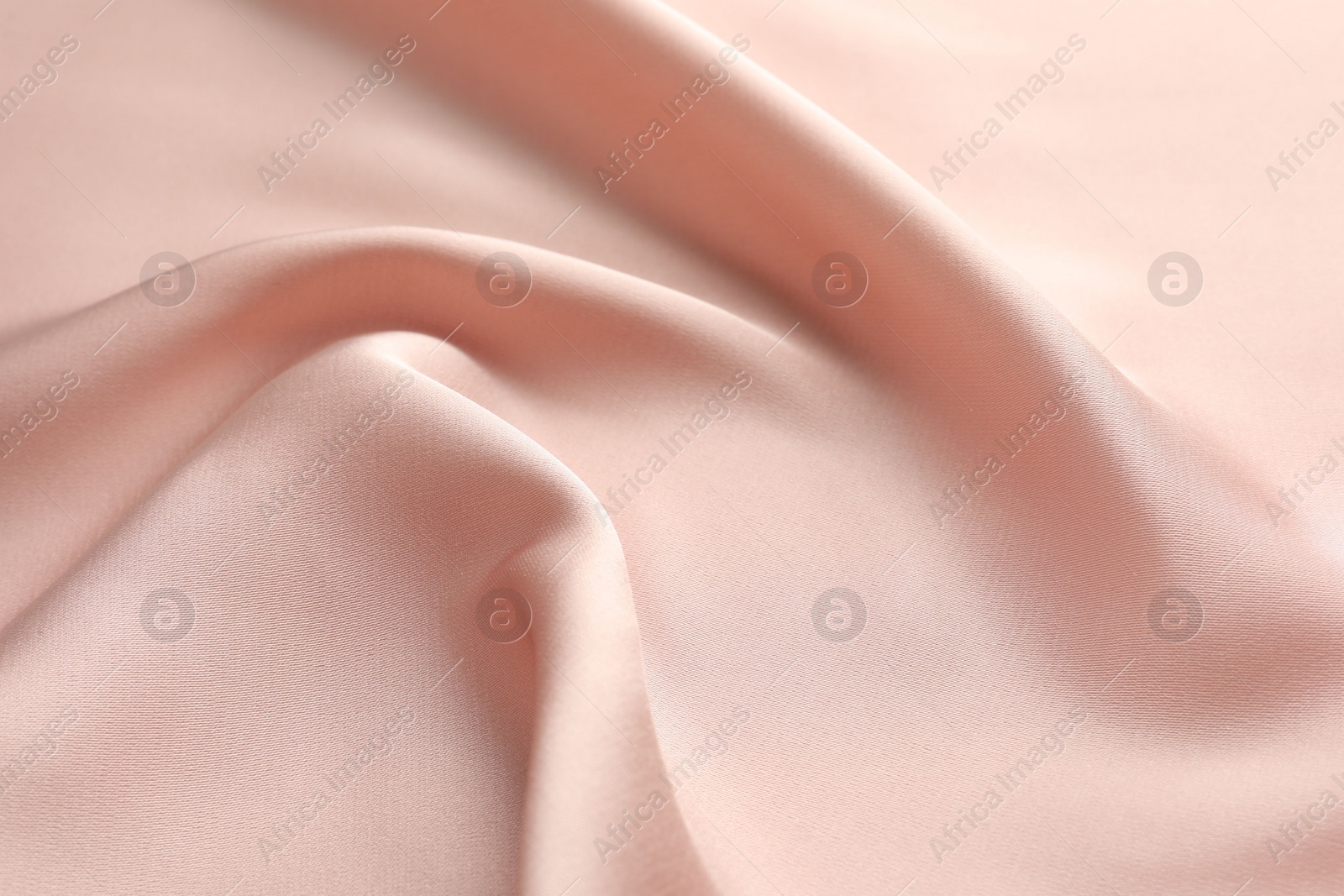 Photo of Crumpled pink silk fabric as background, closeup