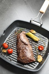 Delicious grilled beef meat and vegetables in pan on grey table, closeup