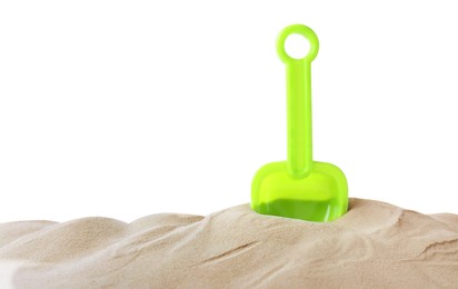 Photo of Light green plastic toy shovel on pile of sand