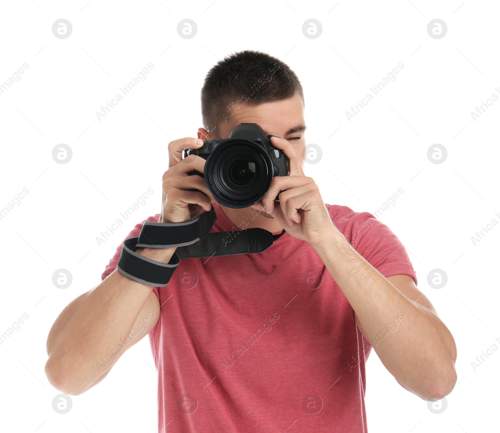 Photo of Young professional photographer taking picture on white background