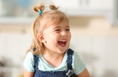 Photo of Funny little girl smiling indoors