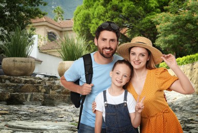 Portrait of happy family with child on city street