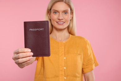 Immigration. Happy woman with passport on background, selective focus
