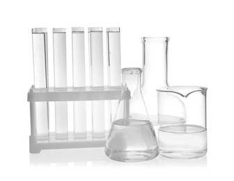 Photo of Laboratory glassware with transparent liquid on white background