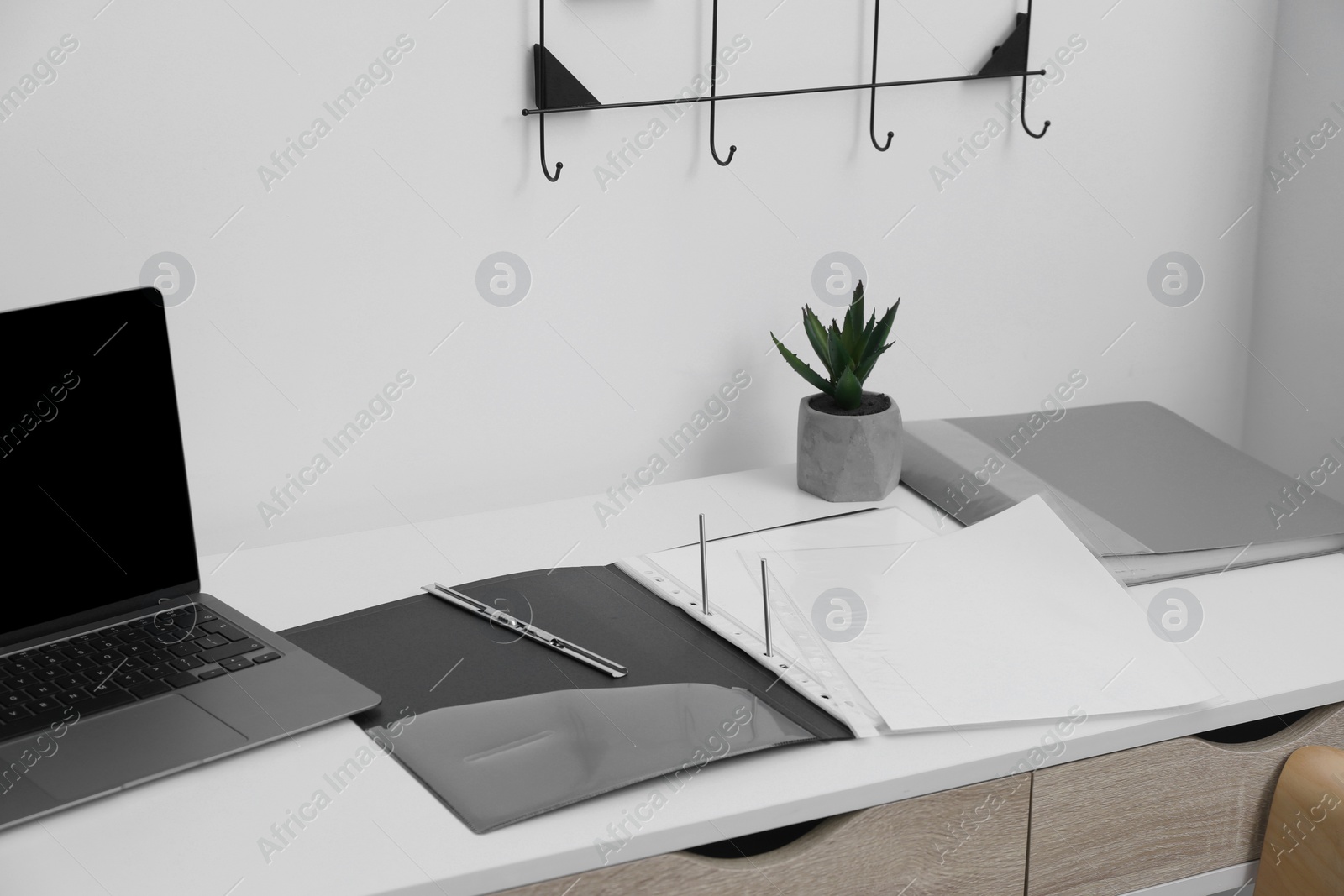 Photo of File folder with punched pockets on white table in office