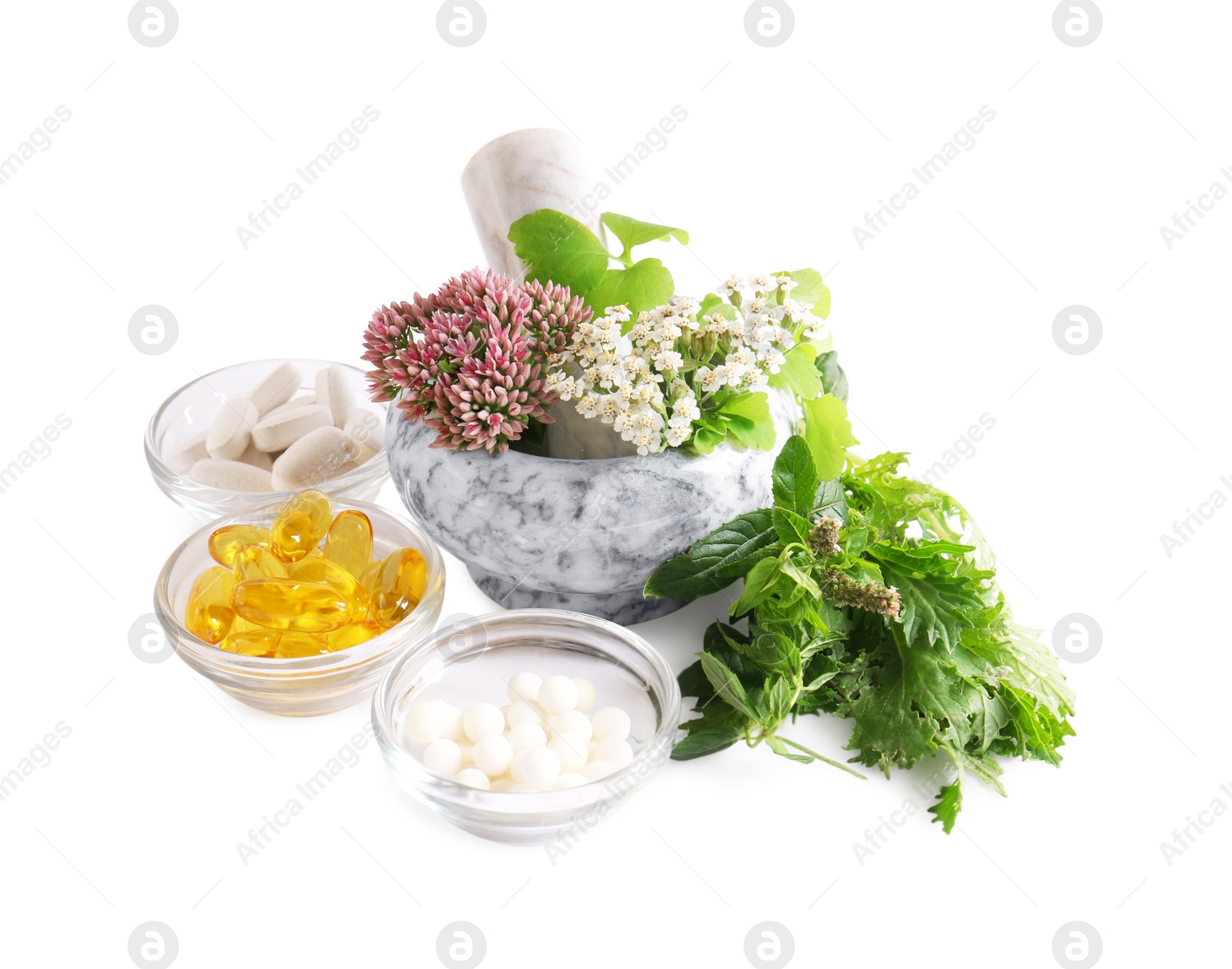 Photo of Marble mortar with fresh herbs and pills on white background