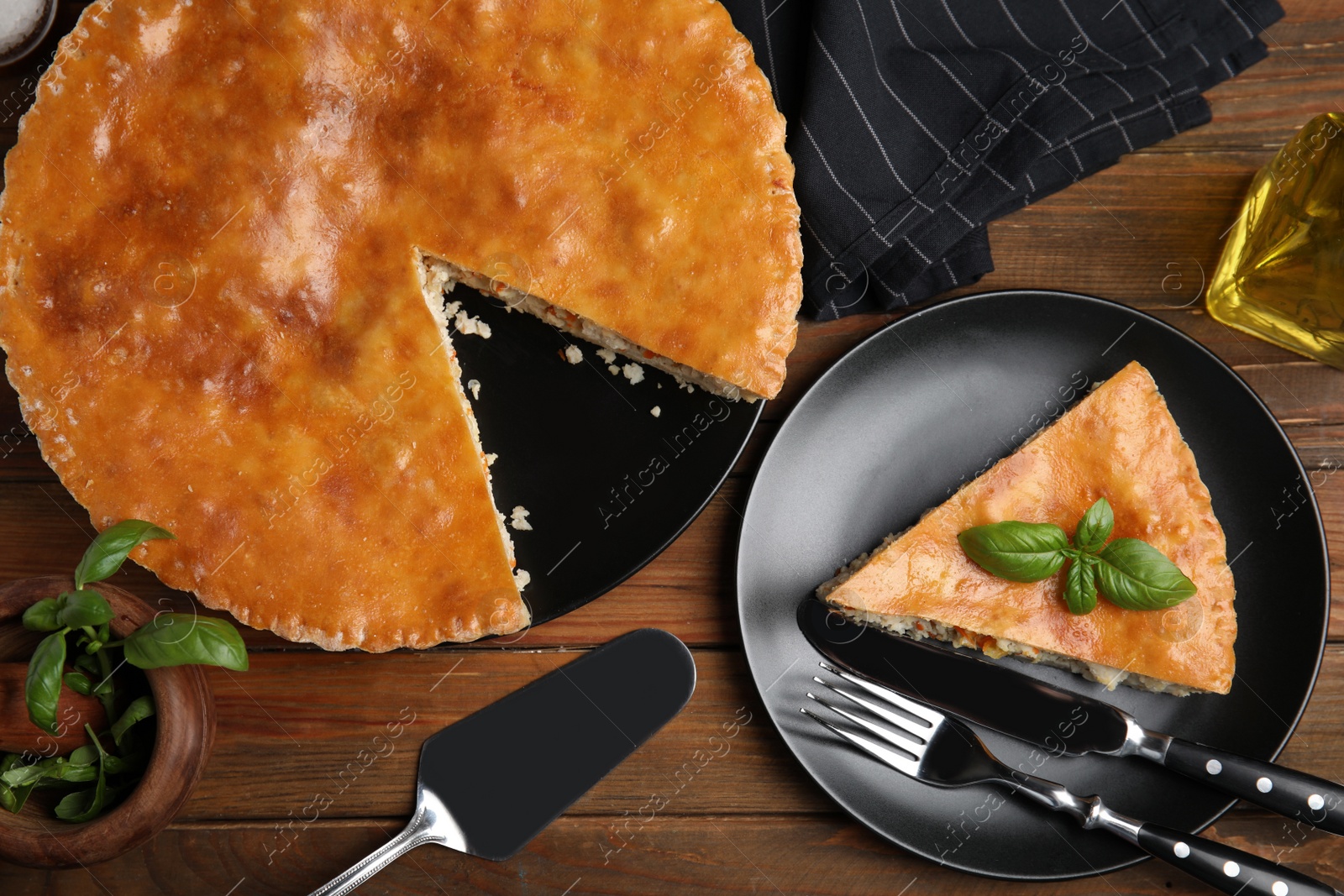 Photo of Delicious pie with meat and basil on wooden table, flat lay