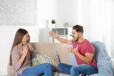 Young couple arguing in living room. Relationship problems