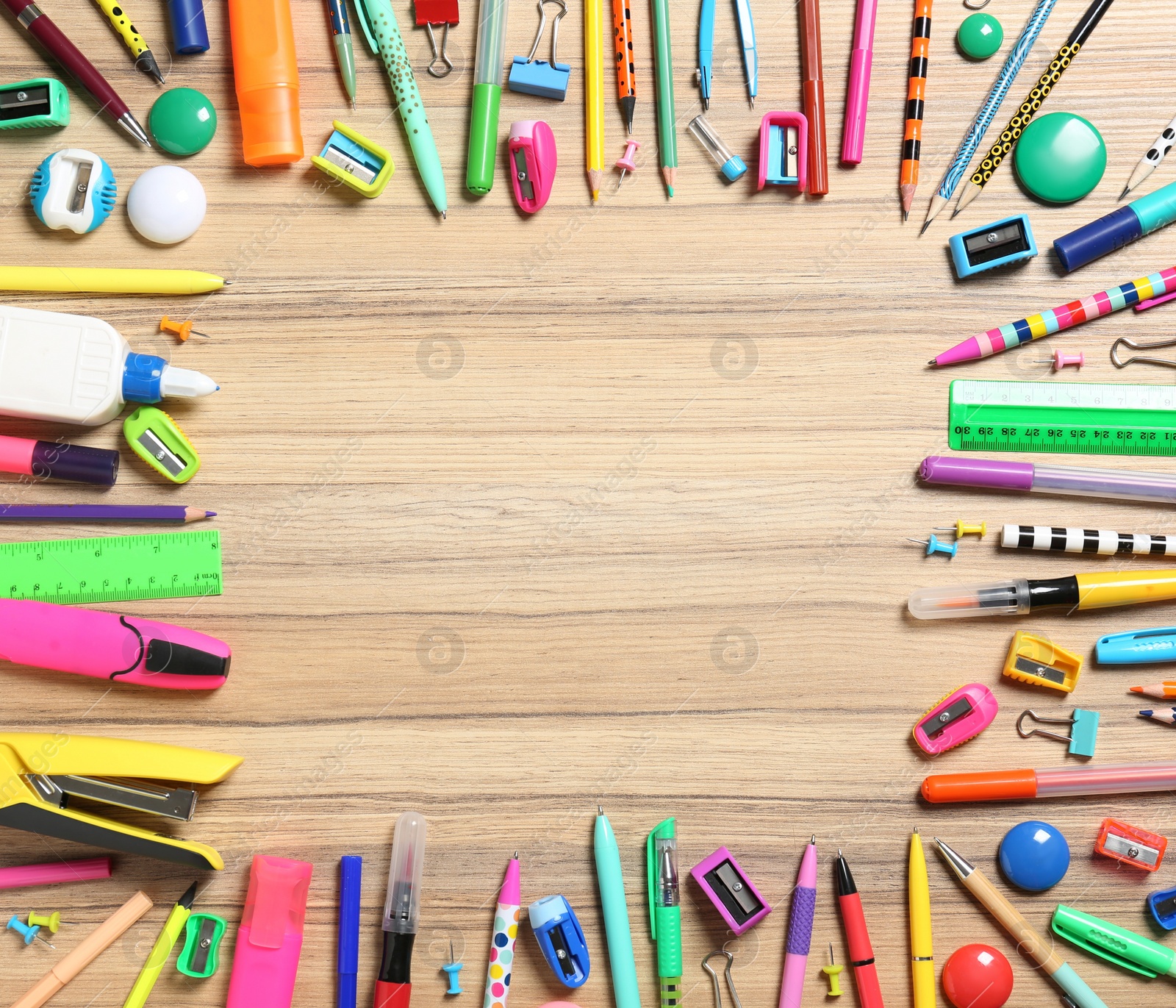 Photo of Frame of different stationeries on wooden background, flat lay. Space for text